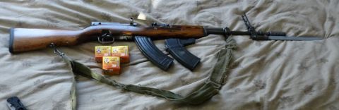 2006 Ford E350 - An SKS rifle is displayed with its bayonet attached, two magazines, and three boxes of ammunition.