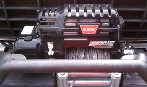 1979 Ford Bronco - Close-up of a Warn PowerPlant Dual Force HD winch with visible branding.