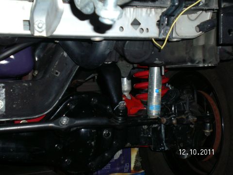 1996 Ford Bronco - Underside view of a vehicle's front suspension system, showing the steering and shock absorbers.