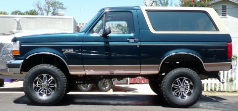 1995 Ford Bronco - This lifted 1995 Ford Bronco is shown from the side with custom wheels.