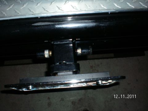 1996 Ford Bronco - Close-up of a receiver hitch plate bracket, showing its metallic components and construction.