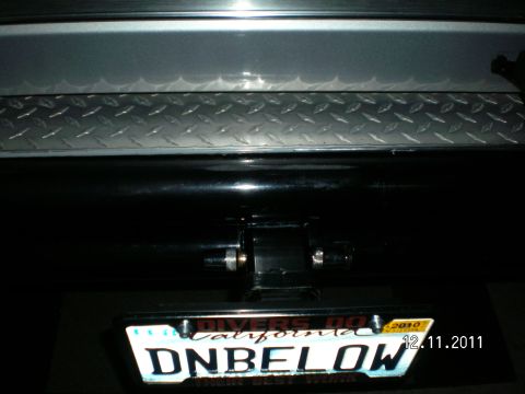 1996 Ford Bronco - A close-up view of a vehicle's rear receiver hitch bracket and license plate.