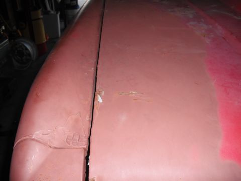 1968 Ford Bronco - Rust and body damage are visible along the seam of a 1968 Ford Bronco's fender and hood.