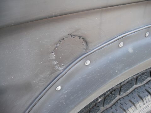 1968 Ford Bronco - This photo shows rust and damage on a vehicle's fender flare, not specific to a 1968 Ford Bronco.