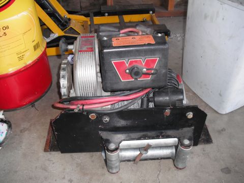 1968 Ford Bronco - A winch with a prominent red 'W' logo is shown, with associated wiring and a metal drum.