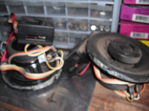 1968 Ford Bronco - Two car speakers with wiring are shown, along with a black electronic box, possibly for audio.