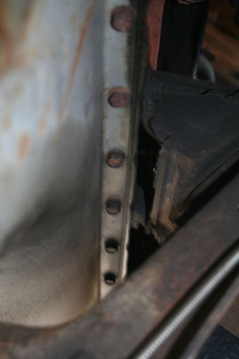 1982 Ford Bronco - Underside view of vehicle frame components, showing bolts and a rubber mount.