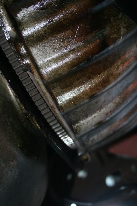 1982 Ford Bronco - Close-up view of a transmission bell housing and flexplate, likely during removal.