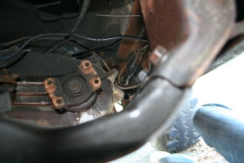 1982 Ford Bronco - Underside view of a vehicle's drivetrain, focusing on the connection between the driveshaft and transmission.