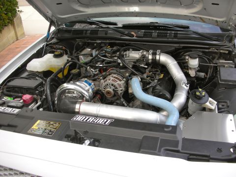 2004 Ford Crown Victoria - Custom supercharger system installed in the engine bay of a vehicle, prominent "ADTR.net" branding.