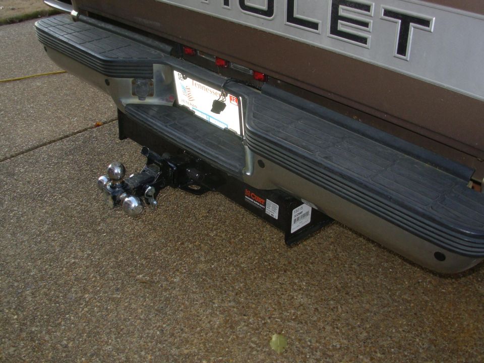 Rear bumper of a Chevrolet truck with a triple-ball hitch installed