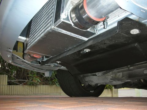 2004 Ford Crown Victoria - Aftermarket intercooler and piping installation shown from a low angle.
