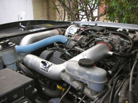 2004 Ford Crown Victoria - Custom engine modifications are visible, including large diameter intake tubes and a supercharger assembly.