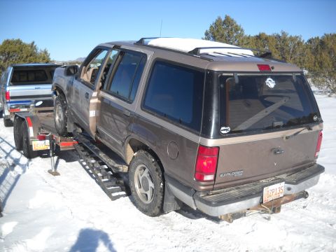 1992 Ford Explorer - Brown 1992 Ford Explorer being loaded onto a trailer in a snowy environment.