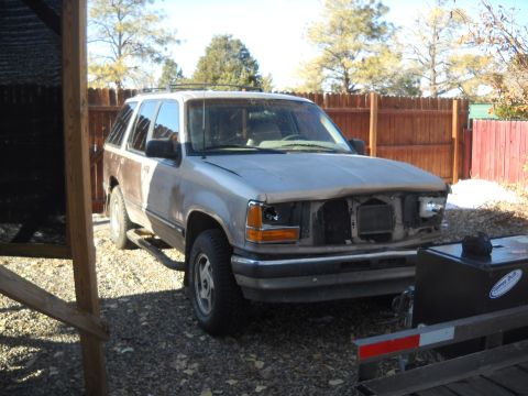 1992 Ford Explorer - This 1992 Ford Explorer is missing its grille and headlights, suggesting it may be a parts vehicle or undergoing repairs.