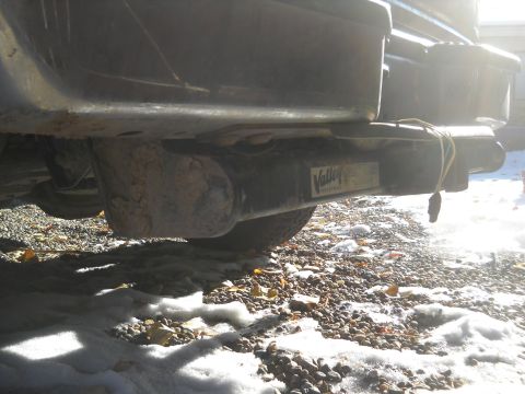1992 Ford Explorer - A close-up view of a trailer hitch assembly, a visible manufacturer's sticker and electrical wiring.