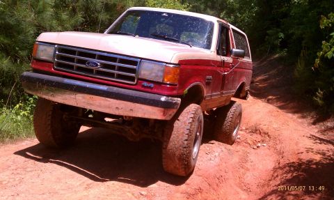 1987 Ford Bronco - This 1987 Ford Bronco is navigating a challenging off-road course with steep inclines.