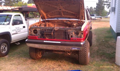 1987 Ford Bronco - This 1987 Ford Bronco is parked outside with its hood open, revealing the engine compartment.