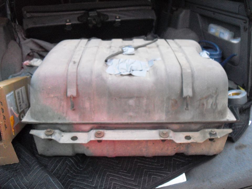 Gas tank with straps, inside a vehicle cargo area