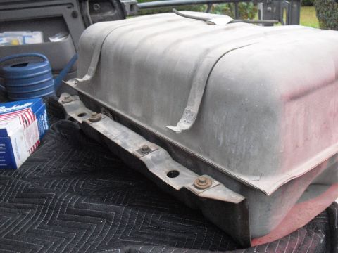 1986 Ford Bronco - A fuel tank, likely for a truck or SUV, is shown removed from a vehicle and placed on a protective mat.