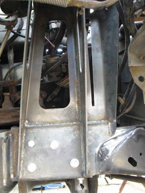 1986 Ford Bronco - Custom metal fabrication, likely part of a vehicle's suspension, shows extensive welding and bolt mounts.