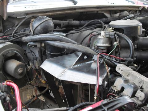 1986 Ford Bronco - Custom metal part installed in the engine bay, obscuring engine components.
