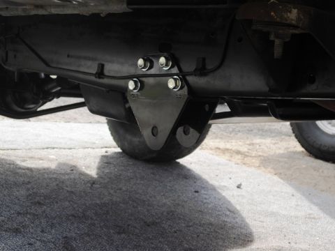 1986 Ford Bronco - Underside view of a vehicle's suspension component, likely a custom bracket.