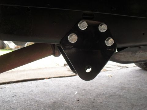 1986 Ford Bronco - A close-up view of a vehicle's suspension mounting bracket and frame.