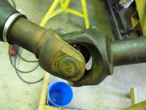 1986 Ford Bronco - Close-up of a driveshaft universal joint, showing part number markings and the Supermotors.net logo.