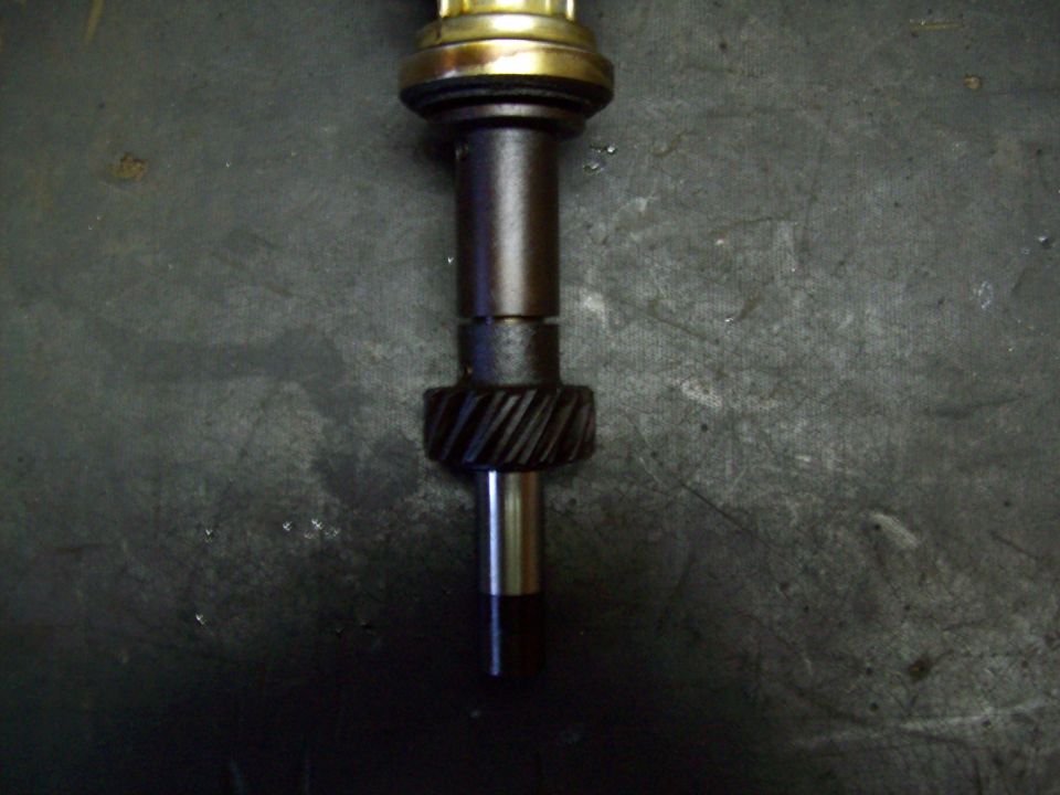 Transmission input shaft with helical gear and bearing on concrete floor
