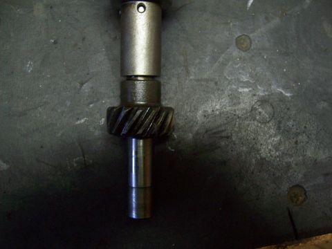 1993 Ford F-150 - Close-up of a metal shaft with a gear and a pinhole, likely an engine component.