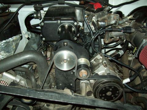 1993 Ford F-150 - Supercharger installed on a vehicle engine, showing belts and pulleys.