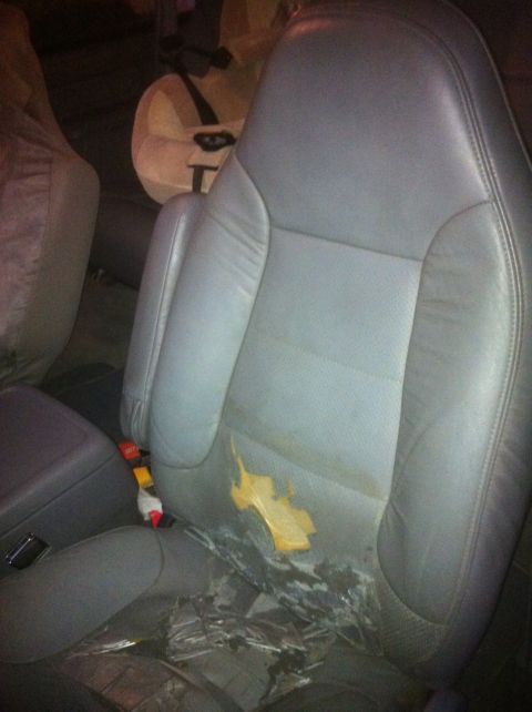 1996 Ford Bronco - Interior view of a car seat showing damage and staining on the upholstery.