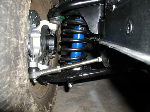 1960 Ford Ranchero - This image shows the suspension system of a vehicle, including a shock absorber and brake assembly.