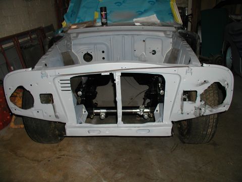 1960 Ford Ranchero - This vehicle's front end is visible, showing exposed suspension and engine bay components, suggesting it is in the process of restoration.