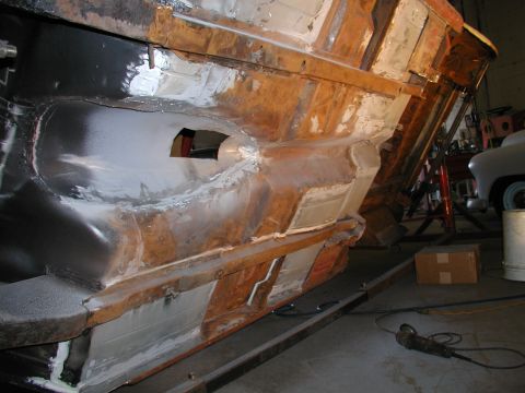 1960 Ford Ranchero - Vehicle frame section showing rust repair and bodywork in progress.
