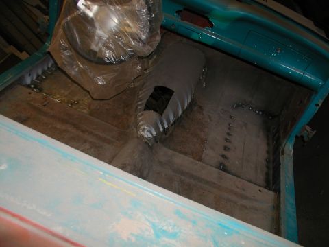 1960 Ford Ranchero - The interior of a vehicle bed shows wooden planks and metal repairs.