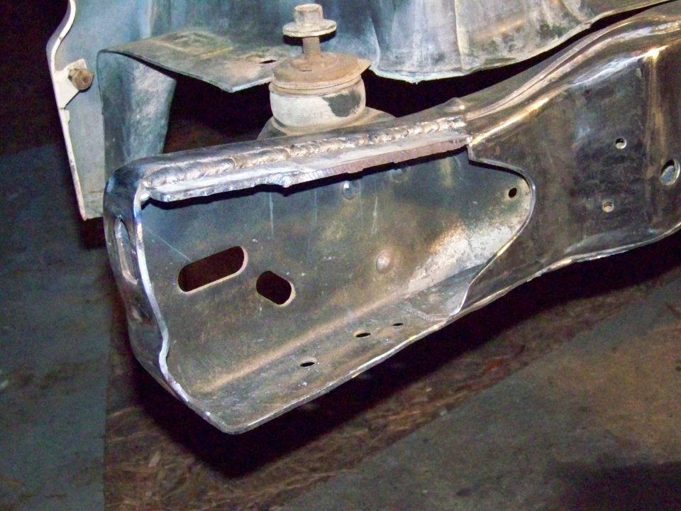 Modified vehicle frame section with visible welds and mounting bracket