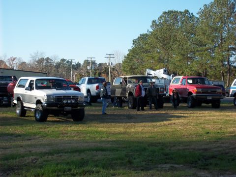 1979 Ford Bronco - A group of off-road vehicles are gathered outdoors on a sunny day.
