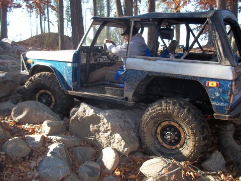 1979 Ford Bronco - This modified Ford Bronco navigates a challenging rocky terrain with its driver at the wheel.