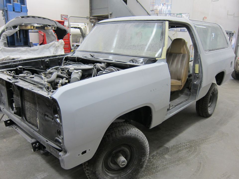 Dodge Ramcharger in a garage, undergoing repairs. Hood is open, showing the engine