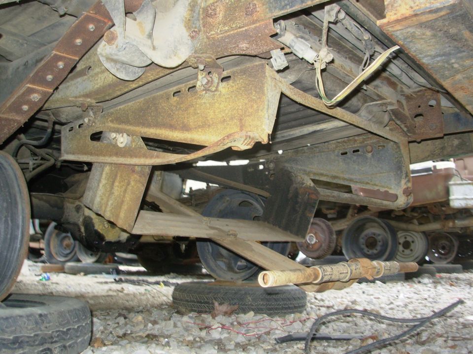 Rusty undercarriage of a vehicle in a salvage yard