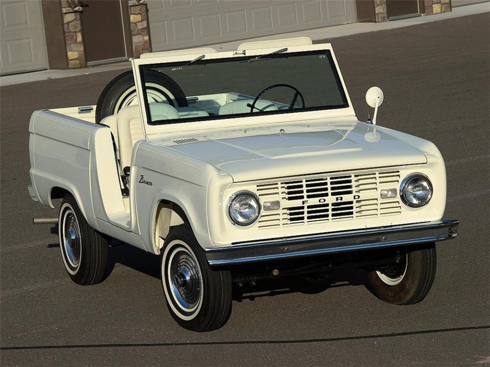 White early Ford Bronco roadster, doors and top off, front 3/4 view