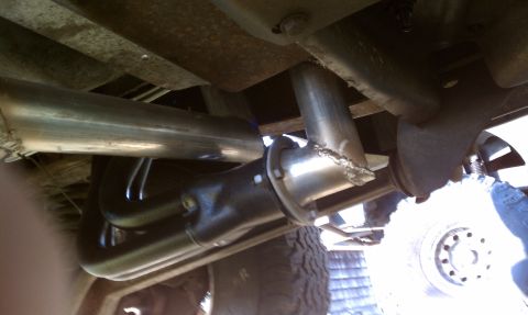 1979 Ford Bronco - Custom exhaust system headers and dual pipes visible from underneath the vehicle.