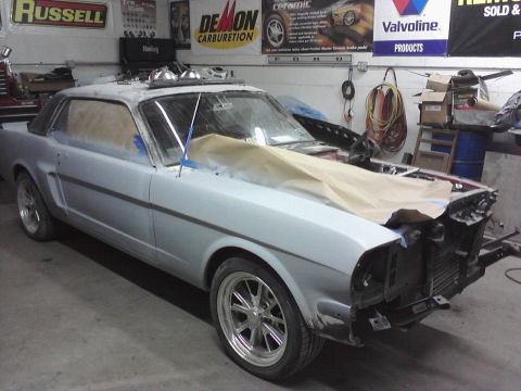1966 Ford Mustang - This 1965 Ford Mustang coupe is in a garage, possibly undergoing body work or restoration.