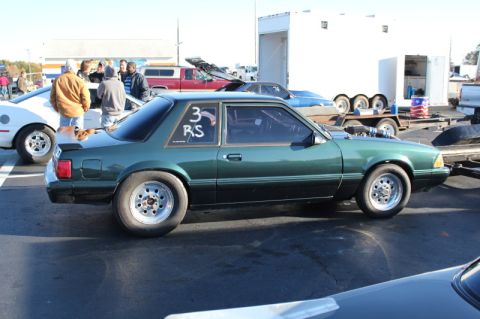 1992 Ford Mustang - A modified green coupe with racing slicks sits on asphalt, possibly at a drag strip event.