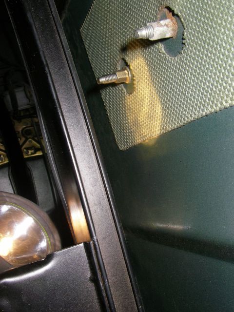 1990 Ford Bronco - Interior view of a car's door frame showing insulation material and a bolt.