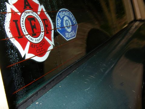 1990 Ford Bronco - Rear window of a vehicle displays IFF and Seattle Fire Department stickers.