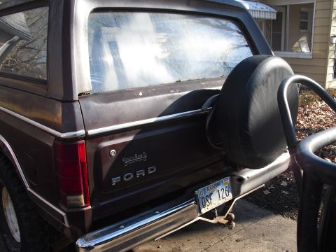 1986 Ford Bronco - Rear view of a 1986 Ford Bronco, showing the spare tire and chrome bumper.