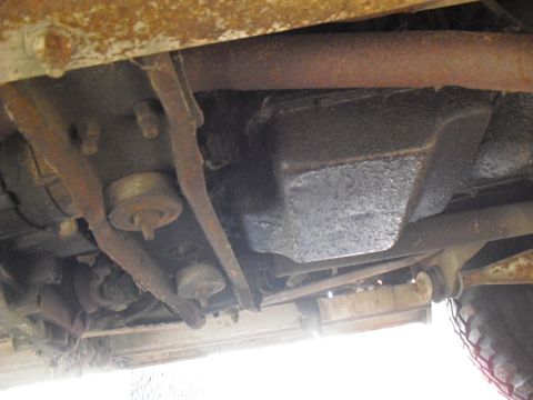1986 Ford Bronco - The underside of a vehicle reveals rusty frame rails and suspension parts, with a Supermotors.net watermark visible.